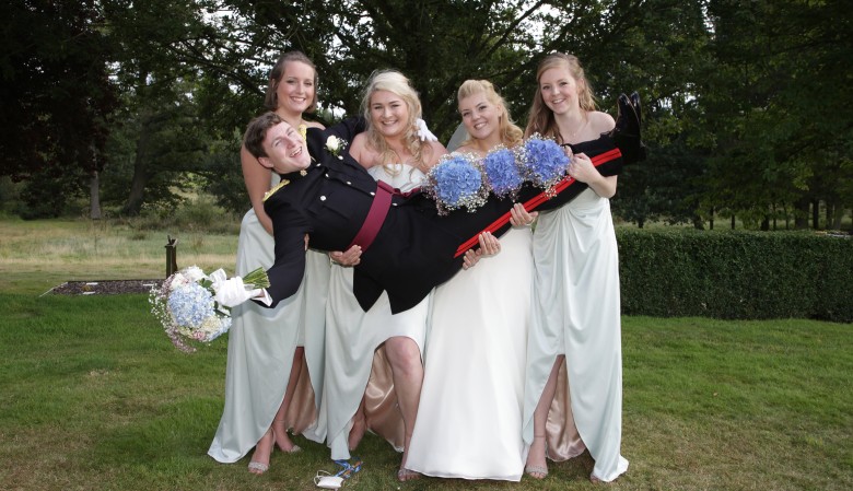 Bridesmaids holding the groom